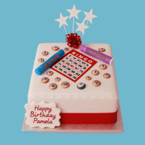 A playful birthday cake featuring an edible bingo card on top, complete with numbered squares and colourful bingo balls arranged around it. Bold, bright numbers on each ball enhance the lively design. Edible bingo daubers are placed around the card, adding to the realistic game setup. A smooth cake base is finished with a vibrant red ribbon around the edge and topped with decorative stars and a festive bow. A custom message is clearly displayed, making the cake personal and fun, ideal for bingo-themed parties and birthday celebrations.