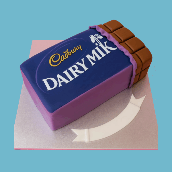 A novelty cake designed to look like a Cadbury Dairy Milk chocolate bar, featuring smooth purple fondant that mimics the iconic packaging. The top displays the detailed Dairy Milk logo alongside a glossy, raised chocolate bar section with realistic square segments. A fondant banner at the base holds a personalized message space. The cake’s vibrant colors and realistic design make it an eye-catching centerpiece for birthdays or special occasions, especially for chocolate lovers.