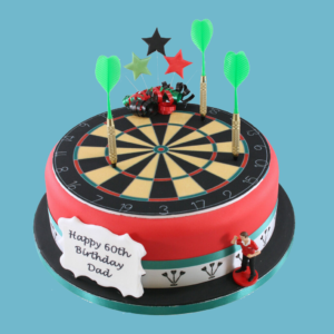 A round, custom Dartboard Cake designed for darts enthusiasts, featuring a realistic dartboard pattern on top with detailed numbers and colours. The cake is wrapped in bold red fondant with green and white bands at the base, small edible dart decorations, and a miniature darts player figure standing beside the board. A customisable message plaque sits at the front, with various flavour and size options available to suit different celebrations.