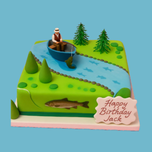 A square cake decorated with a detailed fishing scene featuring a small edible figure sitting in a boat casting a fishing line into a blue fondant river. The river flows gently through a landscape of varying shades of green fondant trees and foliage, with small fish visible in the water. The cake’s natural colors and intricate design evoke a peaceful outdoor fishing trip. There is a customizable edible plaque for personalized messages. The overall look is vibrant and lifelike, perfect for celebrating fishing and outdoor adventures.