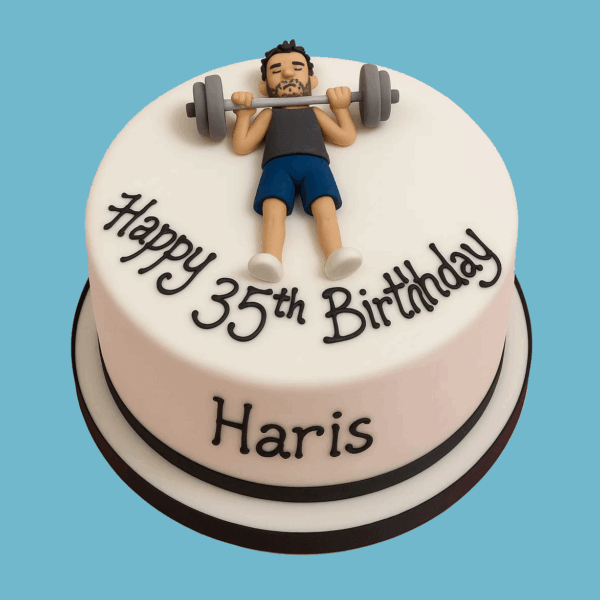 A round cake with a smooth white fondant surface, featuring a fondant figure lying on a workout mat mid-exercise while lifting a barbell with weights. Additional fondant gym accessories like a water bottle, towel, and dumbbell surround the figure. The design includes personalised outfit details and colours, creating a fun and fitness-themed centrepiece ideal for gym lovers and health enthusiasts.
