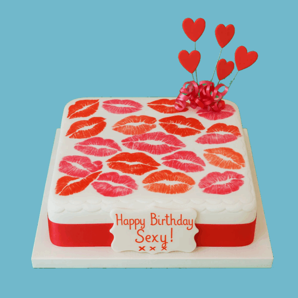 A square cake decorated with a bold, all-over kiss print pattern in vibrant colors, giving it a playful and flirty pop art-style appearance. A personalized message plaque sits on top, and colorful heart-shaped toppers complete the fun, eye-catching design. Ideal for birthdays, hen parties, and themed celebrations, the Kiss Print Cake is fully customizable in print colors, message, topper shapes, and flavors like vanilla or chocolate. A stylish and memorable dessert centerpiece that adds energy and personality to any event.