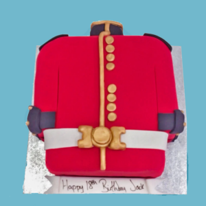 A detailed cake shaped like a military uniform jacket, featuring a bright red base with black collar and cuff accents. A white fondant belt wraps around the middle, while gold fondant stripes, buttons, and decorations add an elegant touch. The cake includes space at the base for a personalized banner message. It is designed for various celebrations like birthdays, retirements, or military-themed events, and can be customized in size, colors, and flavors to suit different occasions.