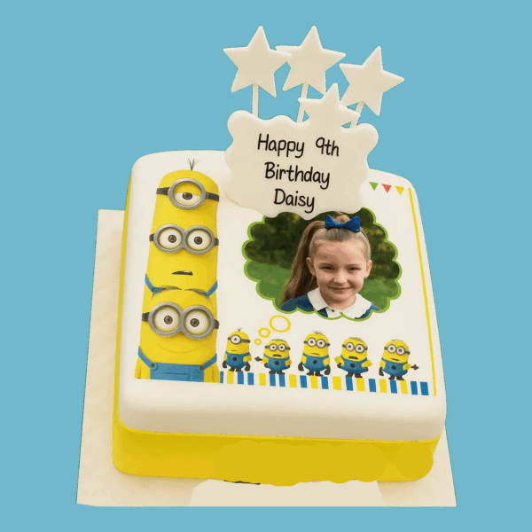 A colourful square Minions-themed photo cake featuring playful yellow Minions surrounding a central edible photo frame. The cake showcases vibrant yellow and blue tones, with Minions peeking over edges and striking silly poses. A personalised message plaque sits at the base, and bright star toppers add a festive touch. Designed as a fun, customisable centrepiece, it’s ideal for kids’ birthdays or themed parties, combining humour, bold colours, and personalisation. Ask ChatGPT