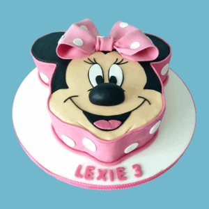 A novelty cake shaped like Minnie Mouse’s face, featuring her round black ears and a large pink bow with white polka dots. The cake shows Minnie’s smiling face with big expressive eyes, using pink, black, and white colors. This detailed and colorful cake is perfect for Disney-themed celebrations or birthdays, appealing to fans of all ages.
