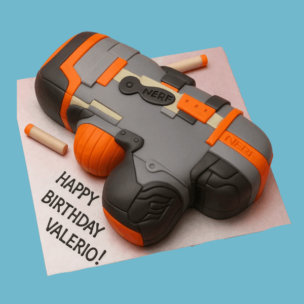 A novelty cake shaped like a Nerf toy gun, featuring bold shades of grey and bright orange with black detailing. The cake includes fondant foam darts placed around the gun for added fun and realism. The design highlights clean lines and vibrant colors, making it an exciting centerpiece for children’s parties or toy-themed celebrations.