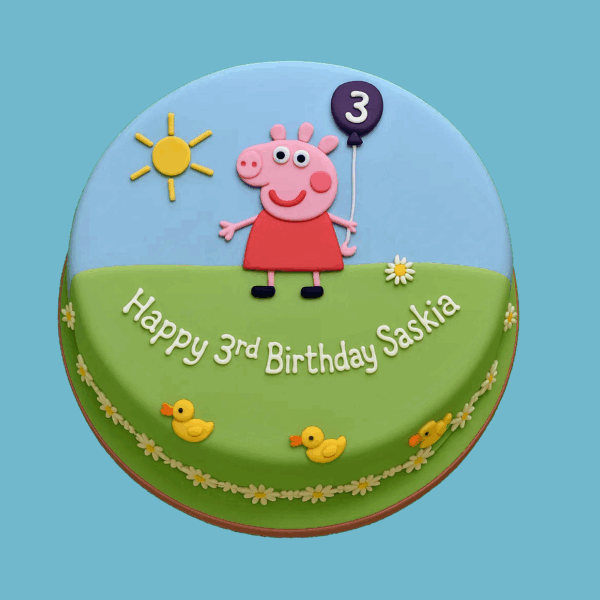 Round Peppa Pig cake with a light blue sky and yellow sun on top, featuring Peppa Pig in the centre holding a red balloon. The base is decorated with green grass and small colourful flowers, capturing a cheerful, child-friendly design.