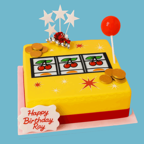 A square cake designed to look like a classic slot machine, featuring detailed spinning reels and shiny coins in vibrant colors. The cake includes a personalized message plaque and decorative star toppers, customizable in color and design. This bold and playful centerpiece captures the excitement of casino games, making it ideal for birthdays, parties, or events with a gambling theme. The moist sponge and smooth icing combine delicious flavor with a visually striking, fun design.
