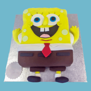 A full-body cake shaped like the cartoon character SpongeBob SquarePants, featuring his bright yellow square body with light green sponge holes, large blue eyes, a protruding nose, and a wide smiling mouth showing buck teeth. The cake includes SpongeBob’s white shirt collar, red tie, brown trousers with a black belt, thin yellow arms and legs, and black shoes, capturing his cheerful and playful look in vibrant colors.