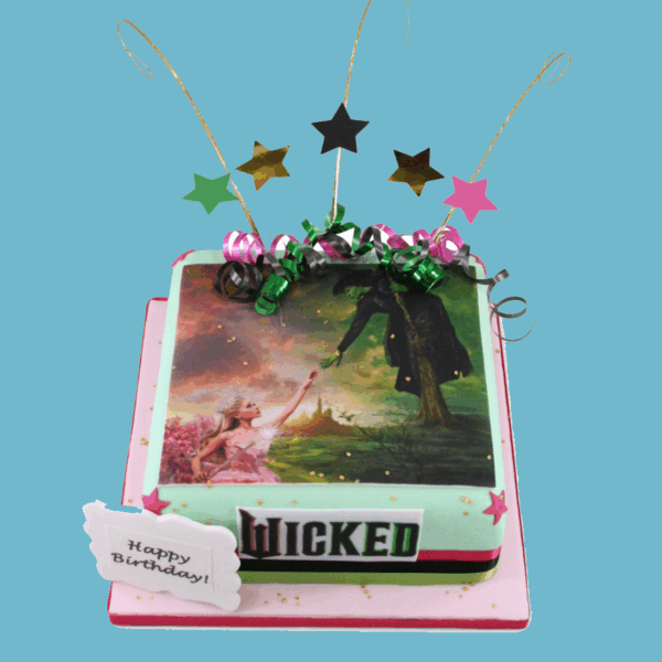 Square Wicked-themed celebration cake featuring a vibrant printed image of Elphaba and Glinda from the musical. The cake is decorated with star toppers and includes a customisable message plaque. Designed with bold colours and theatrical elements, it serves as a striking centrepiece for theatre fans.