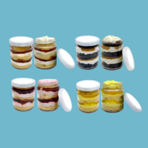 Clear jar filled with layered cake featuring moist sponge, creamy fillings, and colorful frosting. The jar is sealed with a white lid, showcasing vibrant layers including vanilla, chocolate, and fruit flavors. Ideal for portable, single-serving desserts perfect for picnics, office treats, or gifts. The transparent container highlights the textures and colors of the cake inside, making it both visually appealing and convenient to enjoy anywhere.